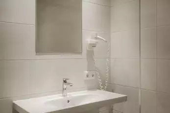 großes Waschbecken mit Föhn und Spiegel